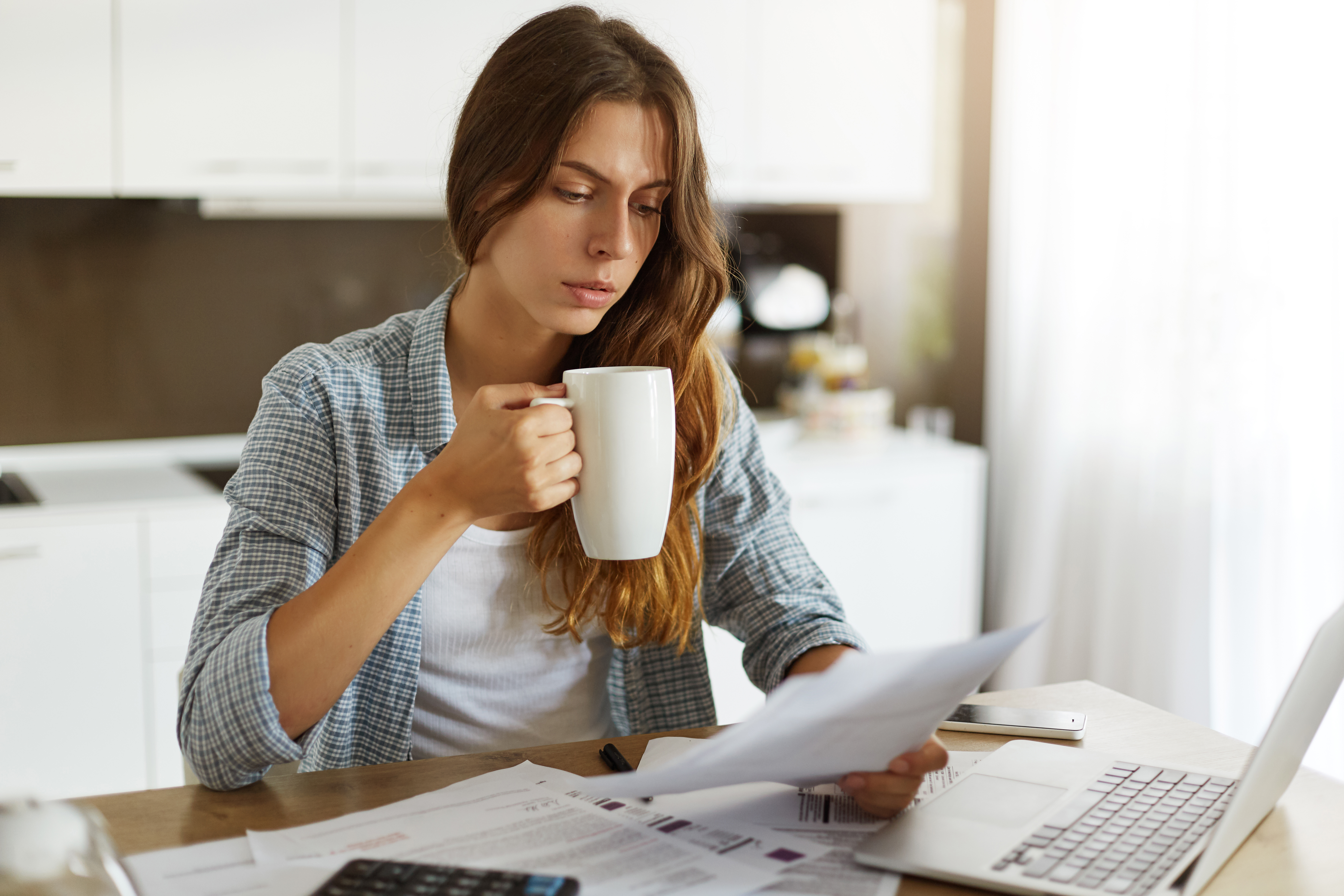 young woman checking her budget doing taxes